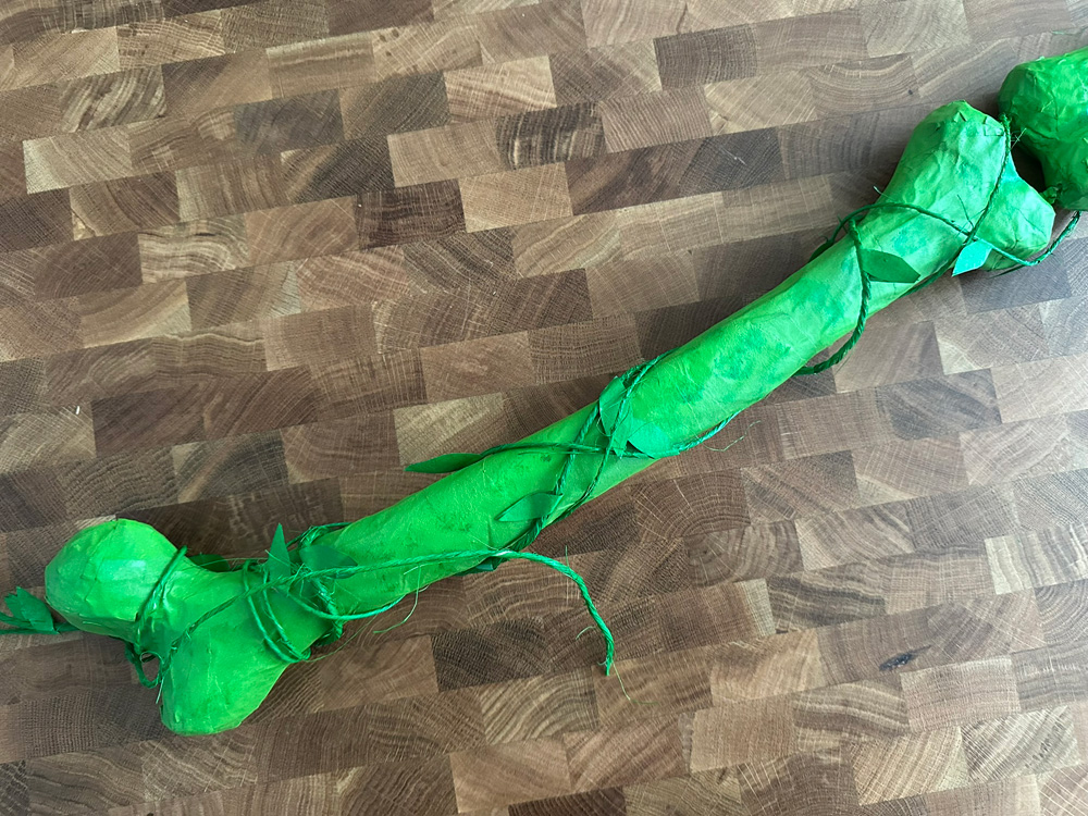 Close up of the upper arm bone, wrapped in fake vines.