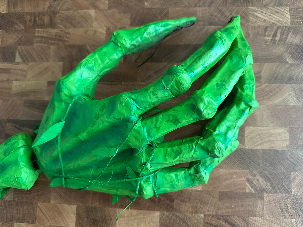 Close up of the finished hand, wrapped in fake vines.
