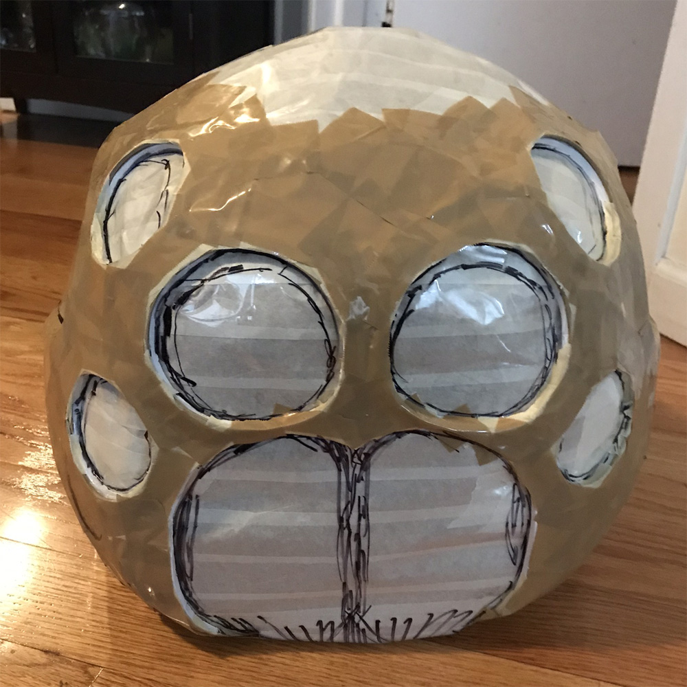 Paper mach&eacute; spider skull mask -- shipping tape on face