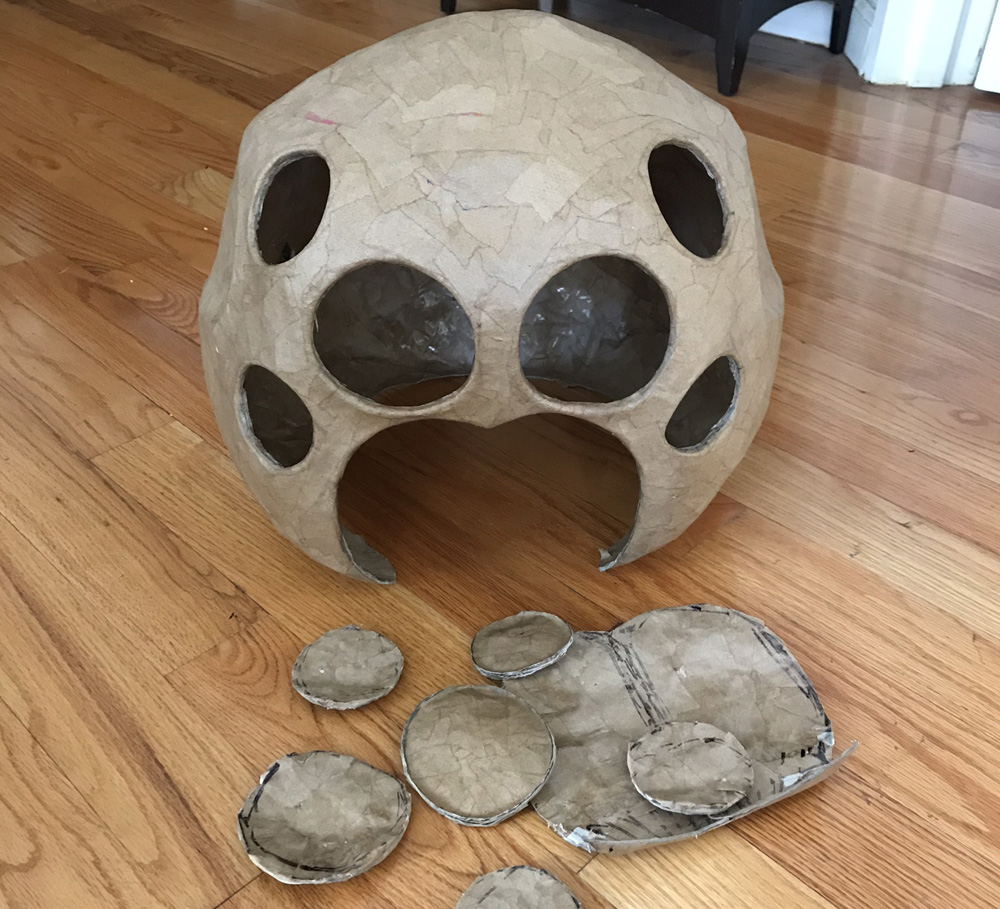 Paper mach&eacute; pider skull mask -- cutting out the eyes and mouth