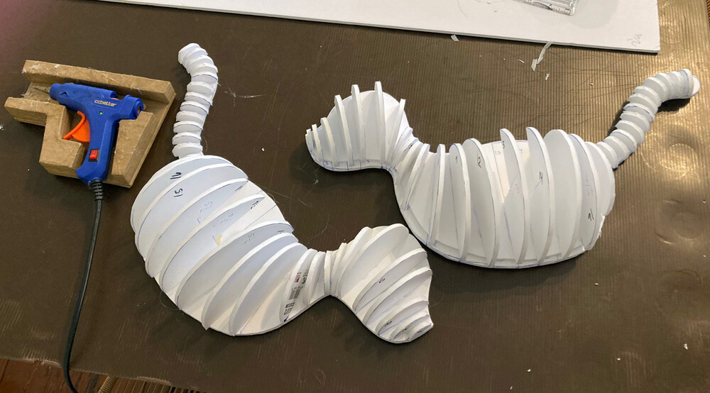 Tiger pinata sculpture - gluing galf circles in place