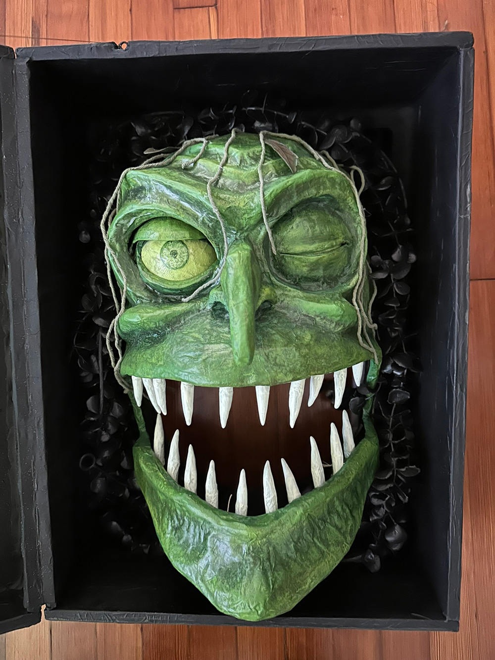 A close up of the witch's face in the box.