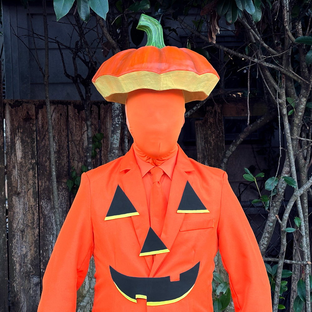 Me wearing my pumpkin lid hat and an orange spandex mask that covers my whole face.