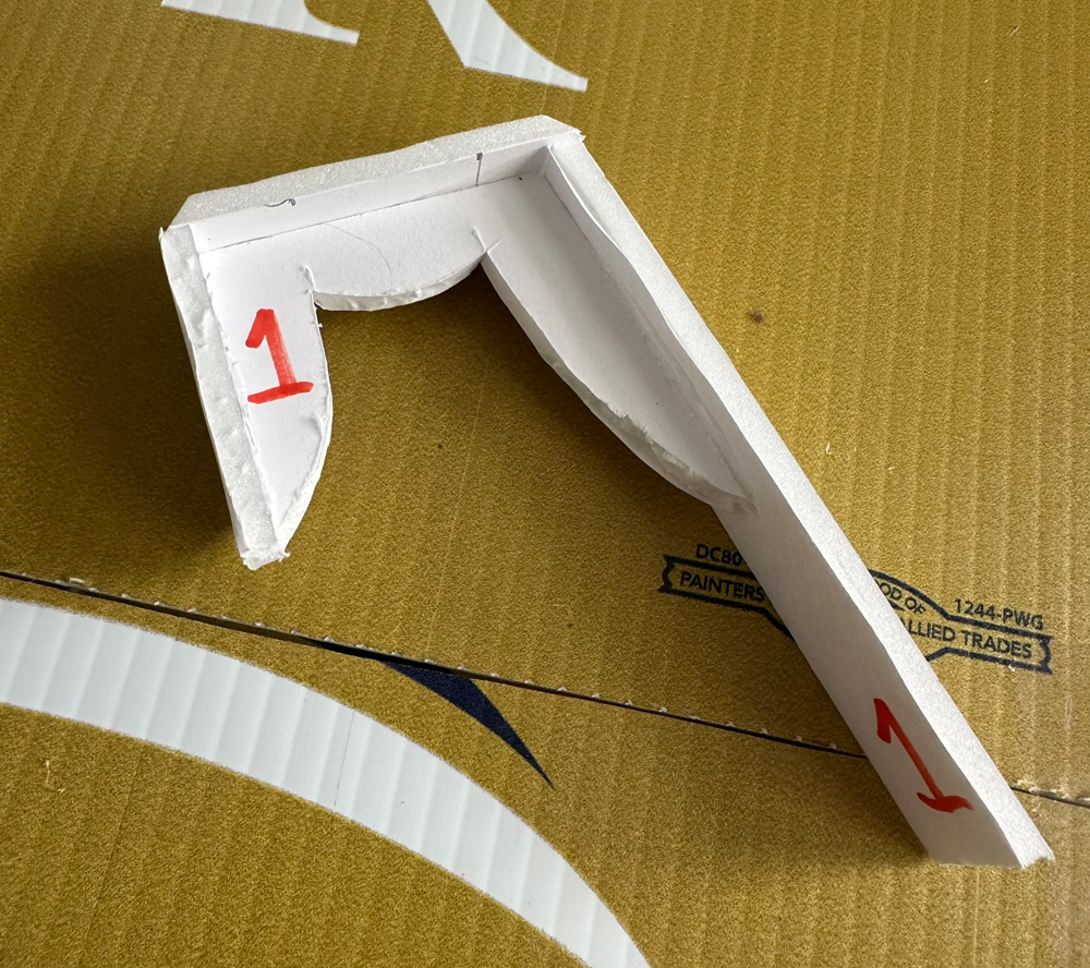 I've added three narrow flat foam board panels to the back of the foam board finger.