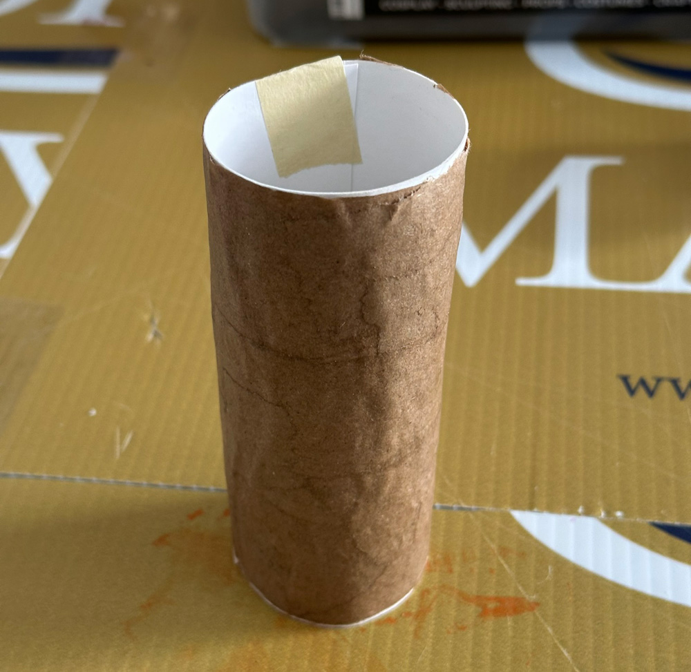 Rolled up poster board tube covered with paper mache.