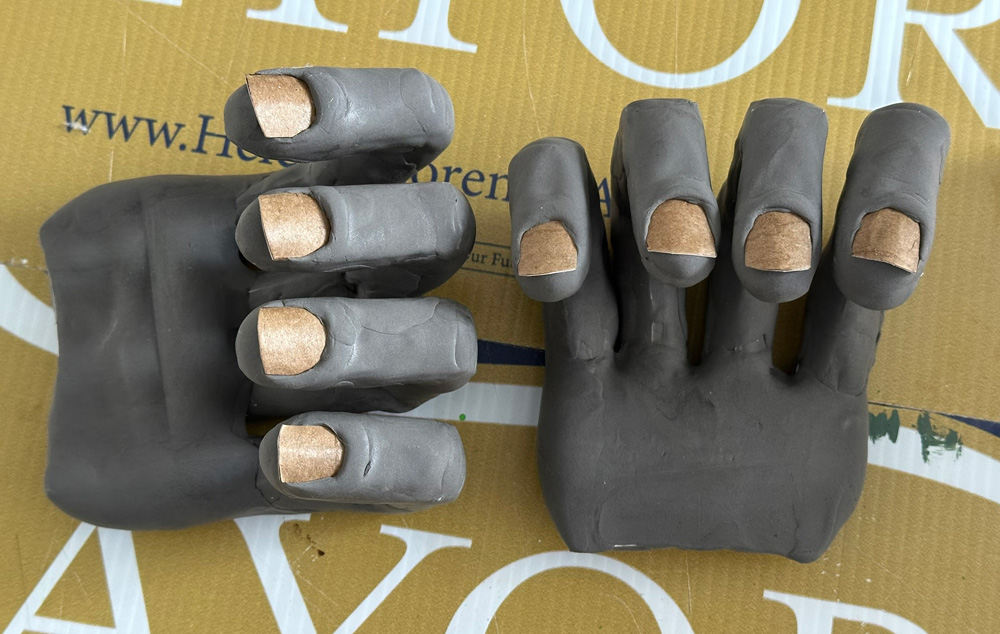 The completed monster hand sculptures before painting.