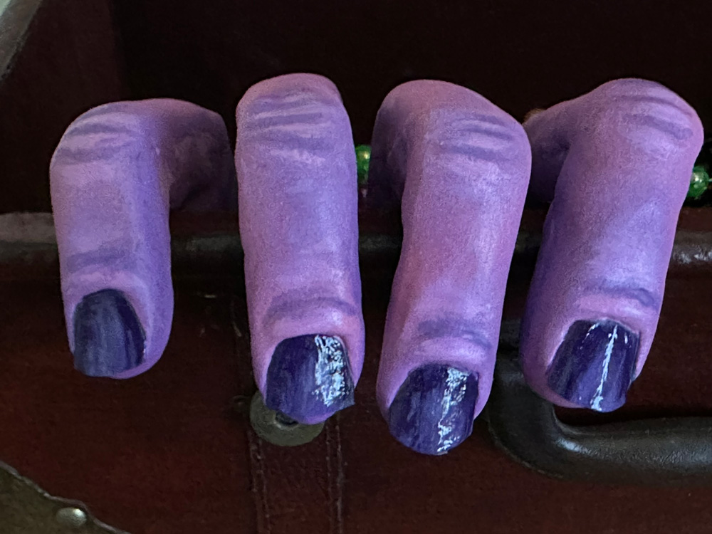 Close up of one of the hands showing the shiny nails.